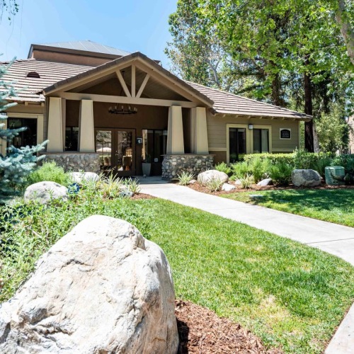 Settle into comfort at Creekside Alta Loma a clubhouse with a large walkway with trees